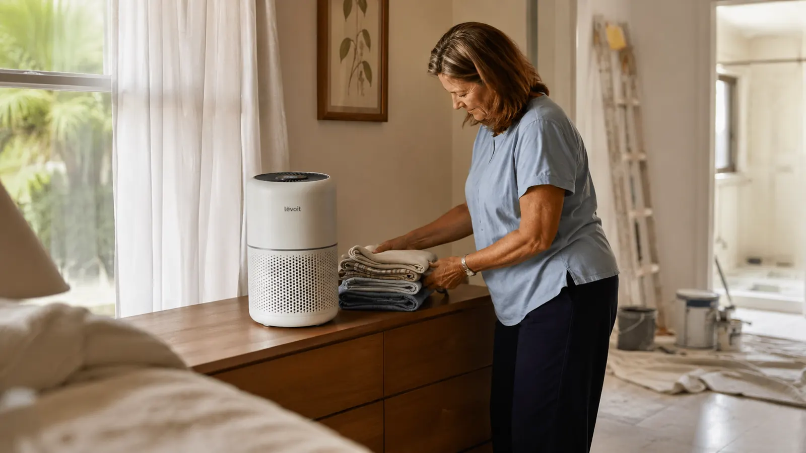 White Levoit Vital 200S air purifier running on a bedroom dresser with soft late afternoon light in a Florida home