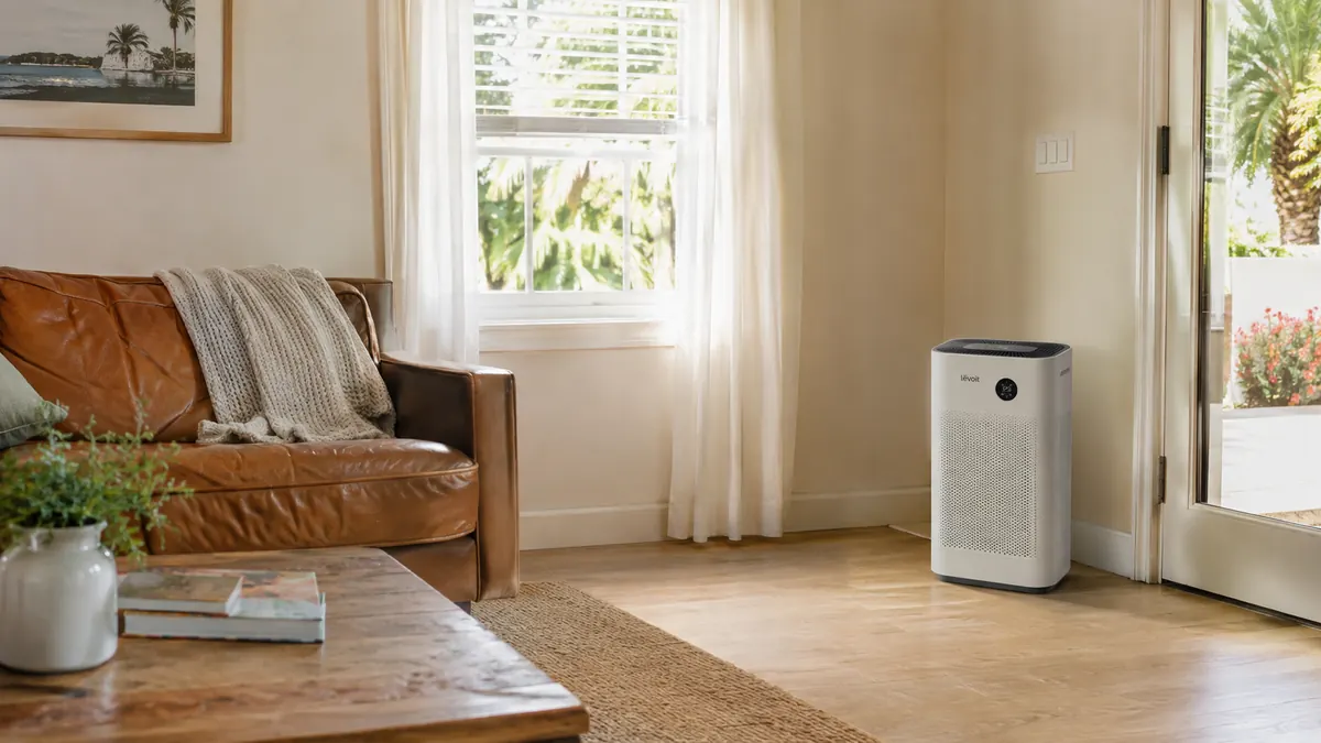Empty sunlit living room with the air purifier running on its highest setting during the day