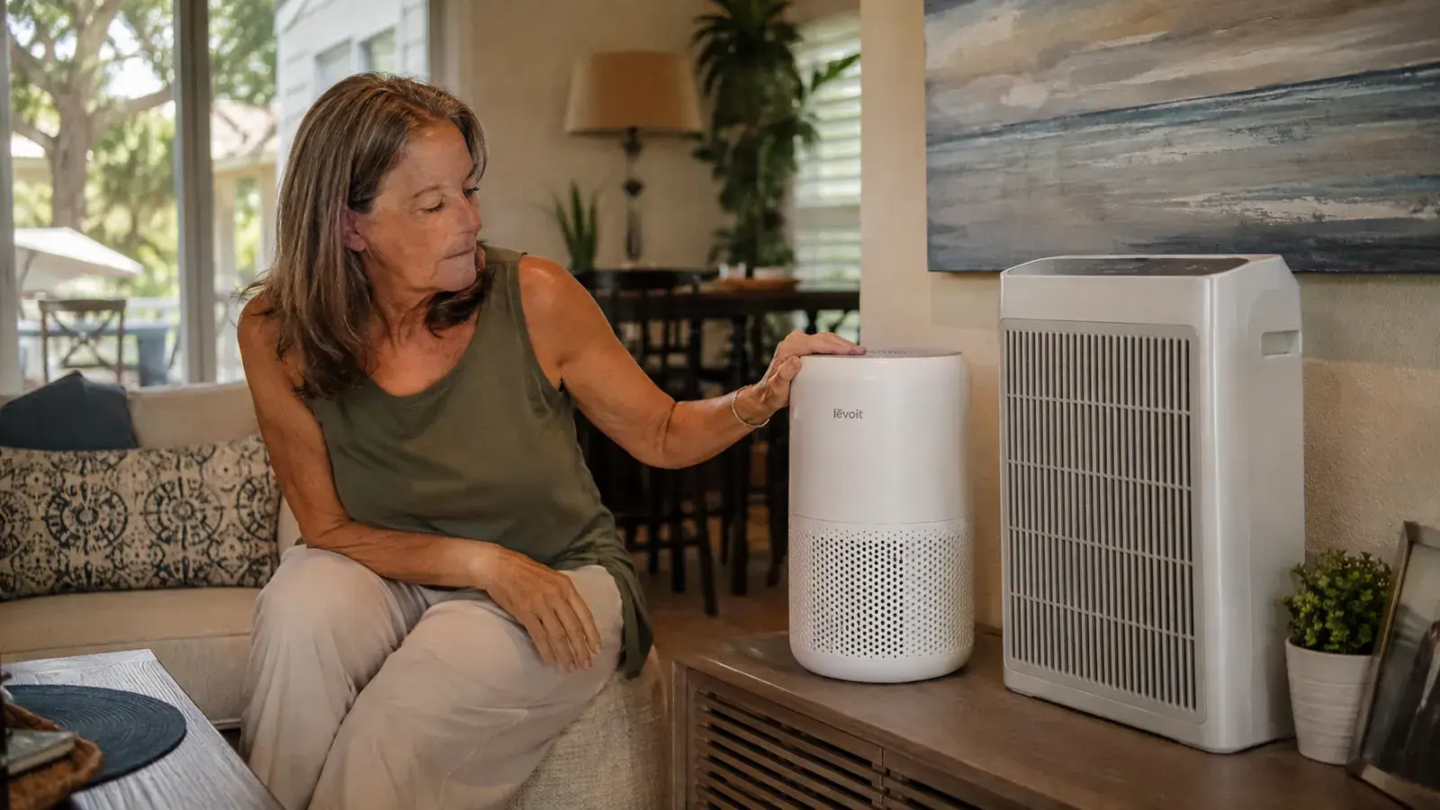 White Levoit Vital 200S purifier and a boxy Honeywell tower purifier positioned in a lived-in Florida living room